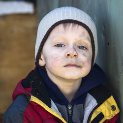 Close-up portrait of boy with soot smear on face