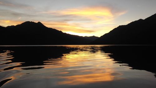 Scenic view of lake against romantic sky at sunset