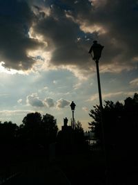 Low angle view of silhouette trees against sky at dusk