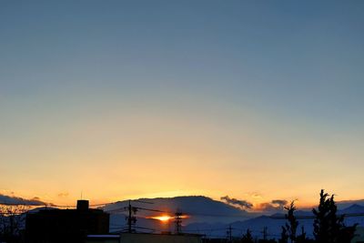 Low angle view of built structures at sunset