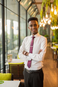 Portrait of young man standing in store