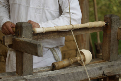 Midsection of man making equipment