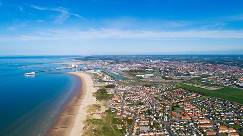 High angle view of bay and cityscape against sky