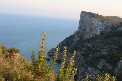 Scenic view of sea and mountains against sky