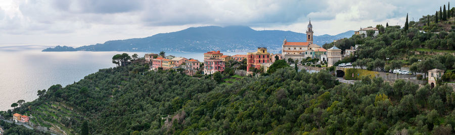 High angle view of townscape by sea against sky