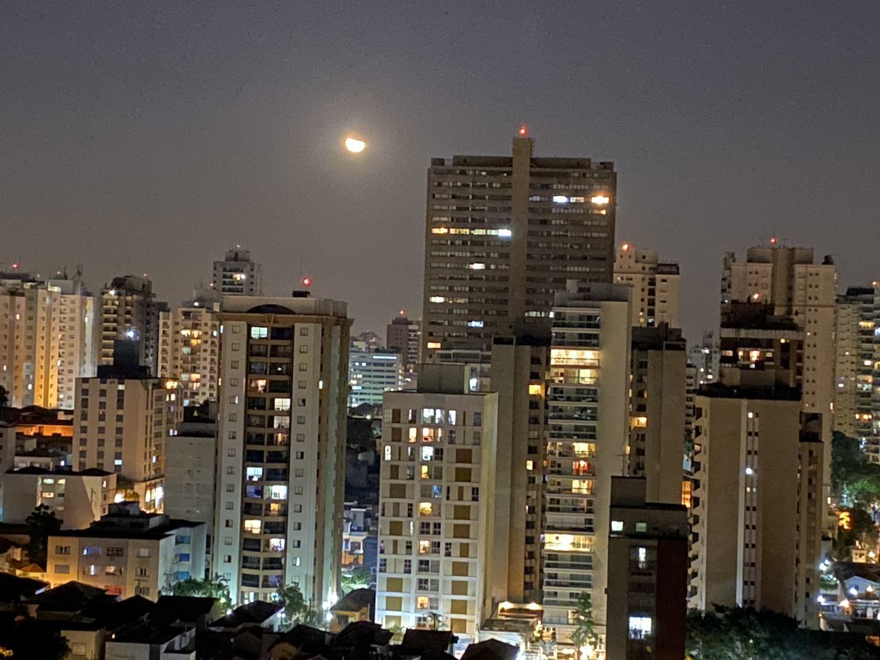 ILLUMINATED BUILDINGS IN CITY AT NIGHT