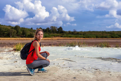 Hiker visits the caldera, a small circular crater with a marsh of sulphurous waters from the volcano