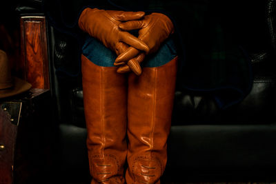 Midsection of man wearing protective clothing while standing in darkroom