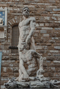 Low angle view of statue against building