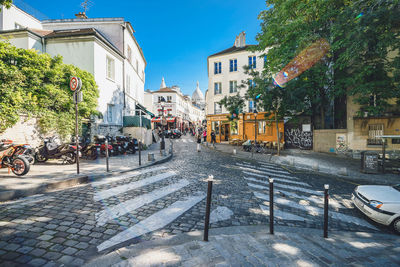 Street amidst buildings in city against sky