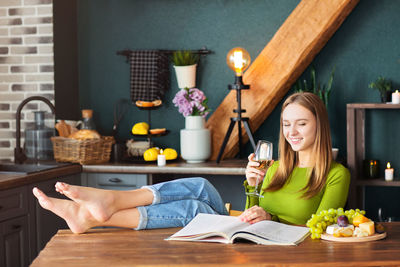 Woman sitting on table at cafe