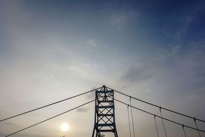 Low angle view of silhouette bridge against sky