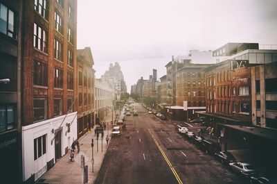 City street amidst buildings against sky