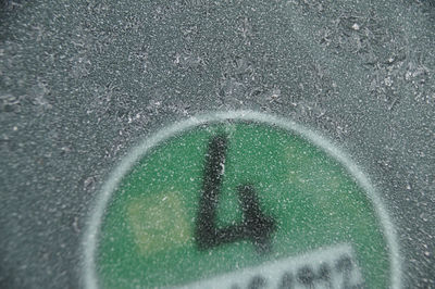 High angle view of road seen through wet glass
