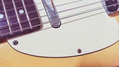 Close-up of guitar on table