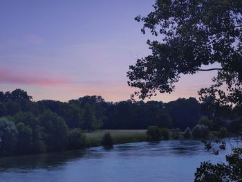 Scenic view of lake against sky at sunset