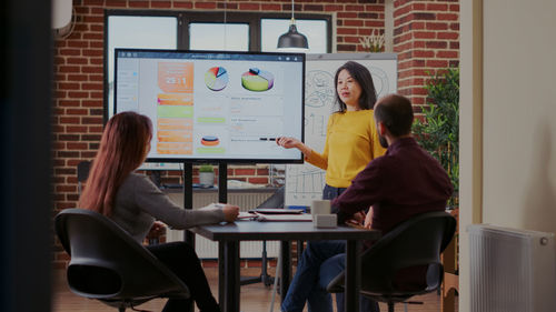 Businesswoman explaining strategy to colleagues in office meeting