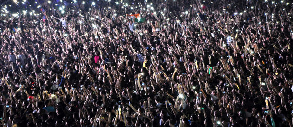 Crowd with arms raised at concert