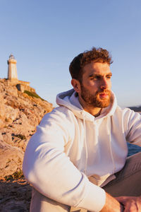 Portrait of boy sitting with a lighthouse person