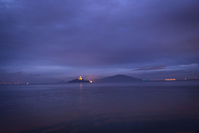 Scenic view of sea against sky at night