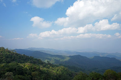 Natural landscape of green mountain range with cloudy blue sky