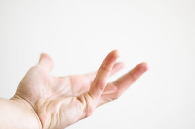 Close-up of hand over white background