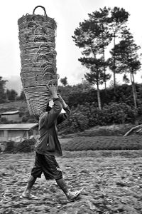 Full length of boy holding umbrella on land