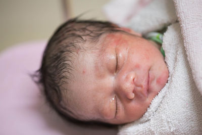 Close-up high angle view of baby boy sleeping