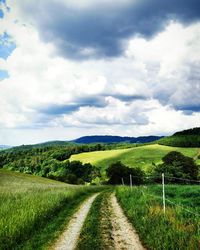 Dirt road along countryside landscape