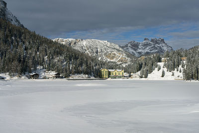 Panoramic view of the frozen misurina lake, in the dolomites mountains, italy, in winter