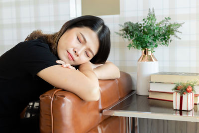 Woman napping on sofa at home