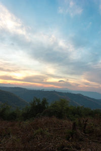 Scenic view of mountains against sky at sunset