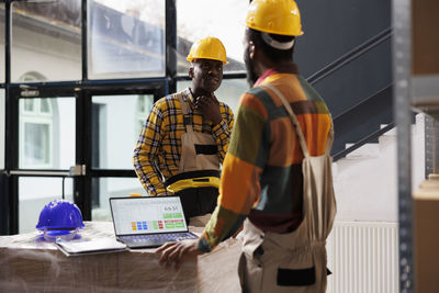 Rear view of man working at office