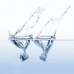 Close-up of water splashing over white background