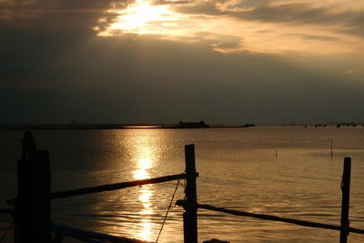 Silhouette of pier in sea