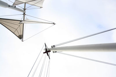 Low angle view of electricity pylon against clear sky