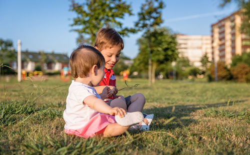 Boy sitting on field
