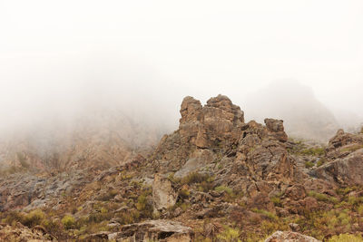 Scenic view of mountain against sky during foggy weather