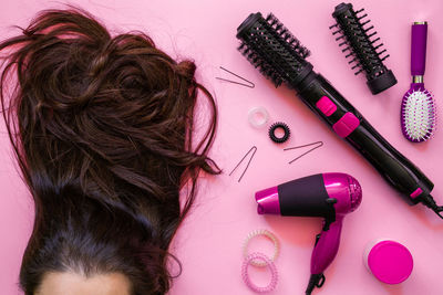 Woman with brown hair by personal accessories on table