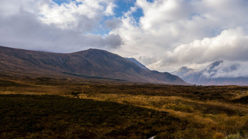 Scenic view of mountains against cloudy sky