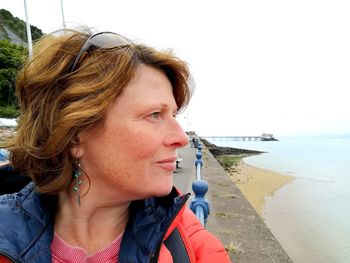 Portrait of young woman looking at sea shore