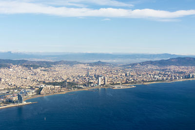 High angle view of buildings by sea against sky