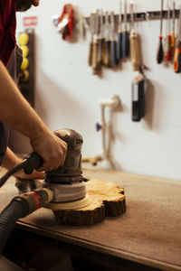 Midsection of man working in workshop