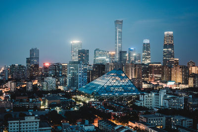 Illuminated cityscape against sky at night