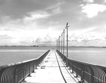 Pier over sea against sky