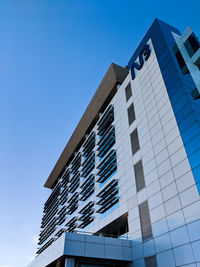 Low angle view of modern building against clear blue sky