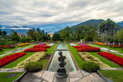 Statues in park against sky