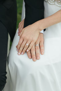 Midsection of couple holding hands