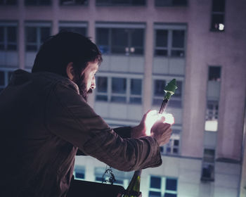 Side view of man using mobile phone