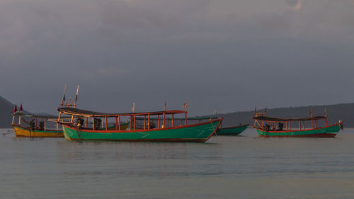 Koh rong island, cambodia at sunrise. strong vibrant colors, boats and ocean